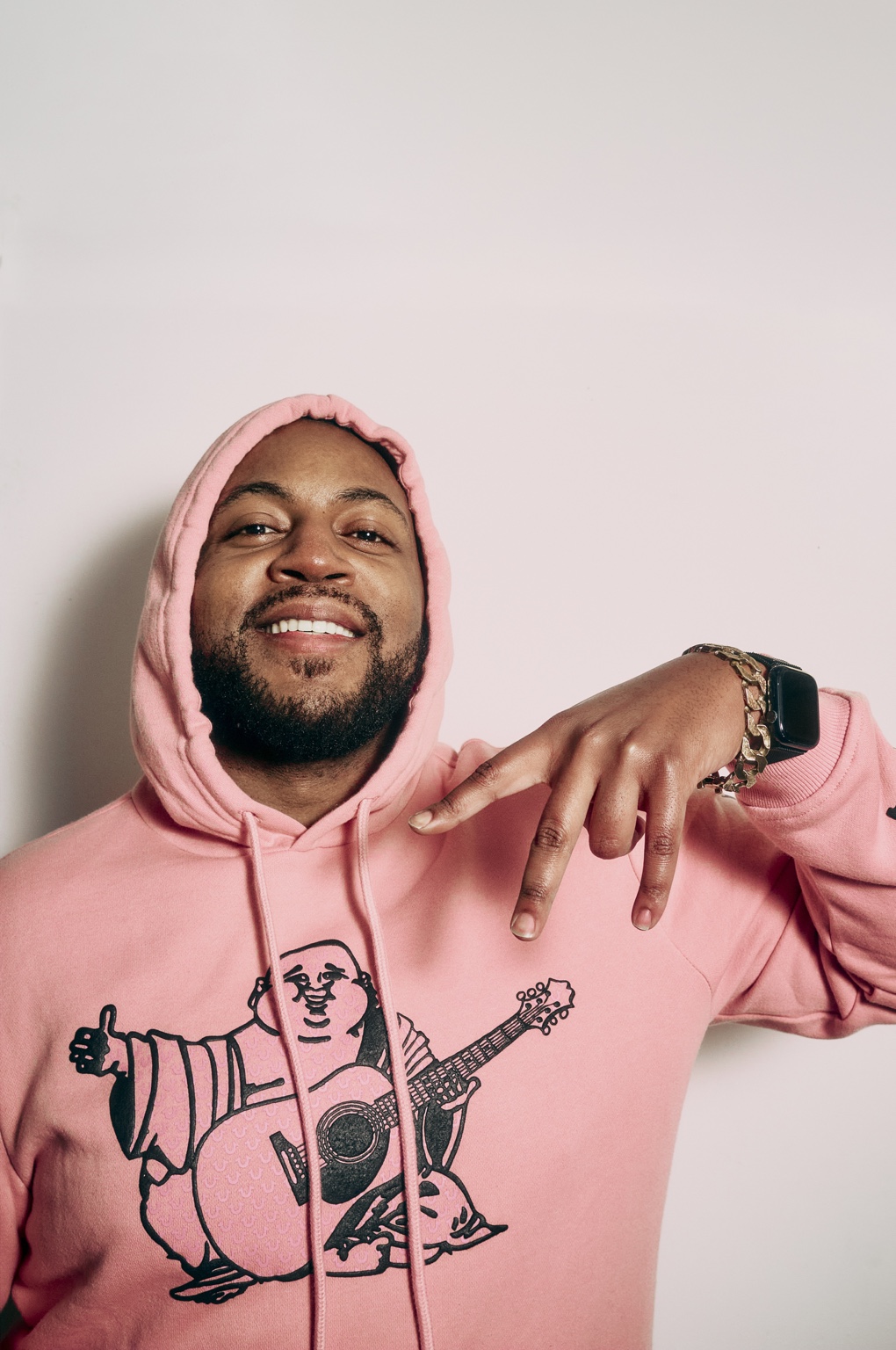 Master S BTB posing in a pink hoodie